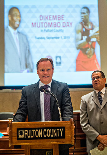 Atlanta Hawks coach Mike Budenholzer (center) speaks during the celebration naming September 1 as Dikembe Mutombo Day in Fulton County at the Fulton County Government Center in Atlanta on Tuesday, September 1, 2015.   