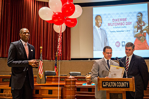 Dikembe Mutombo (left) smiles as Fulton County Chairman John H. Eaves and District 2 Commissioner Bob Ellis read the proclamation naming September 1 as Dikembe Mutombo Day in Fulton County at the Fulton County Government Center in Atlanta on Tuesday, September 1, 2015.   
