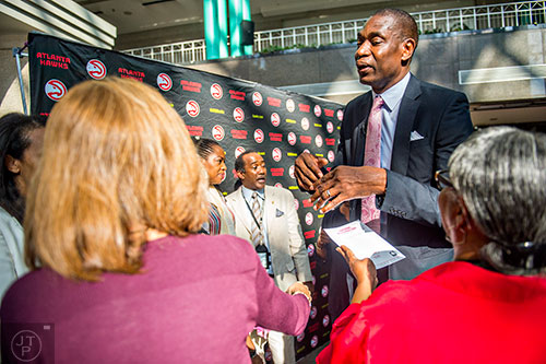 Dikembe Mutombo (right) speaks with friends and fans after the celebration naming September 1 as Dikembe Mutombo Day in Fulton County at the Fulton County Government Center in Atlanta on Tuesday, September 1, 2015.   