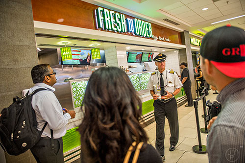 Capt. Dave Oeser (center) waits for his lunch after placing an order at Fresh to Order inside the Hartsfield Jackson Atlanta International Airport on Wednesday, September 2, 2015. 