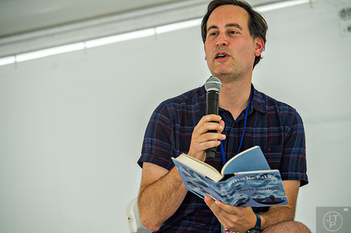 Author David Levithan holds his newest book as he speaks to the crowd during the AJC Decatur Book Festival on Saturday, September 5, 2015. 