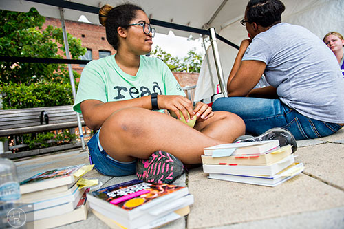 Surrounded by stacks of books, Jasmyn Stamper (left) waits in line to have them signed during the AJC Decatur Book Festival on Saturday, September 5, 2015. 