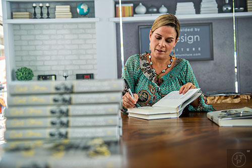 Cat Cora, the first female Iron Chef, signs books during the AJC Decatur Book Festival on Saturday, September 5, 2015. 