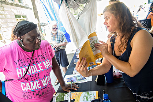 Joyce Farmer - Brown (left) checks out Rebecca Gilbert's book It's Easy to Start Eating Vegan during the Decatur Book Festival on Saturday. 
