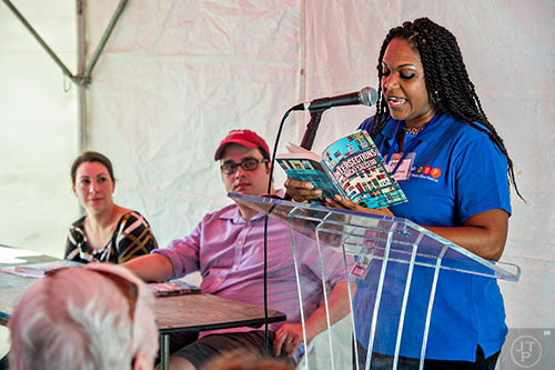Flanked by Decaturish's Dena Mellick (left) and Dan Whisenhunt, columnist Nicki Salcedo (right) reads a selection from her new book Intersections during the Decatur Book Festival on Saturday. 