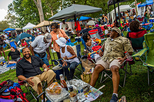Michael Stewart (left) and Glen Battle (right) tell jokes as they sit at their tent during House at the Park at Grant Park in Atlanta on Sunday, September 6, 2015.