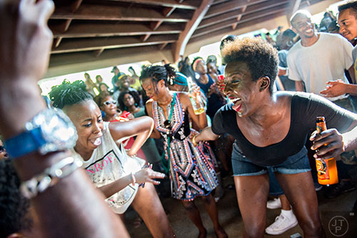 Kim Campbell (right) dances with Natasha Faulkner amidst the throngs of people during House at the Park at Grant Park in Atlanta on Sunday, September 6, 2015.