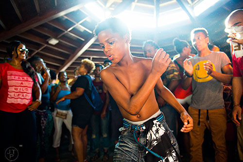 Nine-year-old Donte Neal (center) dances amidst the throngs of people during House at the Park at Grant Park in Atlanta on Sunday, September 6, 2015.