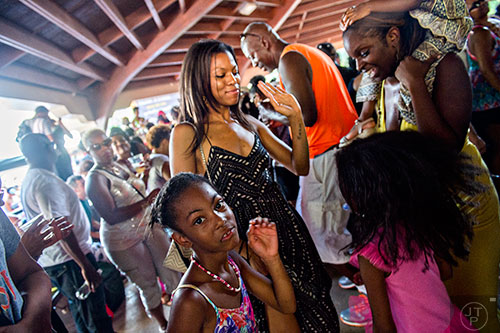 Eden Kearse (left), Brenda Moorer, Shanicia Boswell and Kamryn Banks dance amidst the throngs of people during House at the Park at Grant Park in Atlanta on Sunday, September 6, 2015.