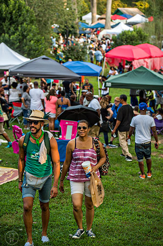 Leonardo Soto (left) and Pam Waller pick a path through the crowd during House at the Park at Grant Park in Atlanta on Sunday, September 6, 2015.