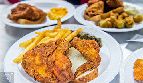 Serving up plates of fried chicken at the newly opened Gus's World Famous Fried Chicken inside the Mall at Peachtree Center in Atlanta on Thursday, August 20, 2015.
