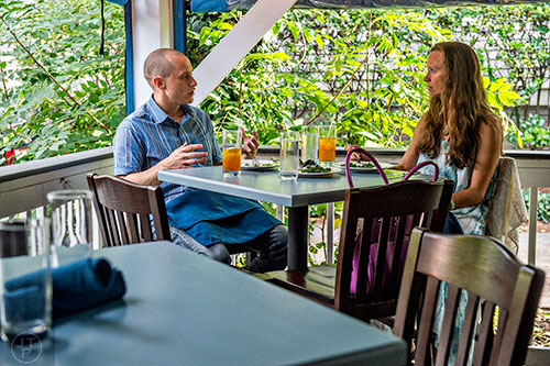Matt Fair (left) and his wife Jennifer enjoy a meal on the porch at Revival in Decatur.