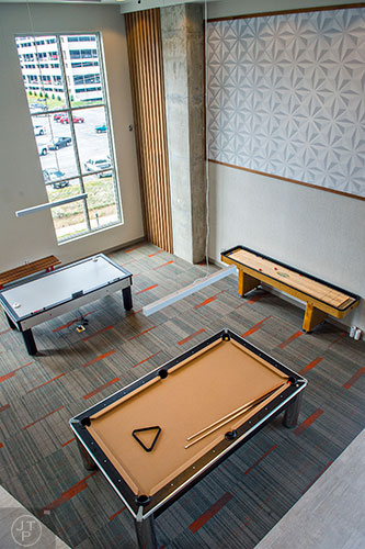 Pool, air hockey and shuffleboard inside the community room at University House in Atlanta.
