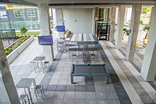 The breezeway at University House in Atlanta has televisions, pool table, ping pong table and places to lounge outside.