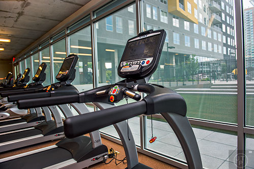 The gym inside University House in Atlanta has all the equipment one would need to stay in shape including treadmills with a view of the outside courtyard and pool.
