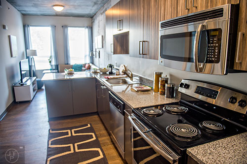 Inside one of the residencies at University House in Atlanta features a kitchen with granite counter tops and stainless steel appliances.