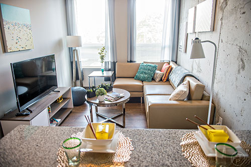 Inside one of the residencies at University House in Atlanta features granite counter tops and fully furnished rooms including a television, couch, tables and lamps.
