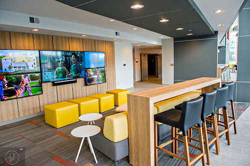 Photo: Jonathan Phillips  The community room inside University House in Atlanta features a multi entertainment setup with five televisions, places to lounge and sit, a game room and access to the pool area and gym.