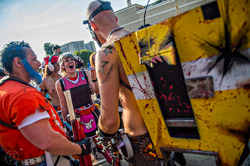 Dressed as Tiny Tina from the Borderlands video games, Carly Monsen (center) talks with other characters as they wait in the marshalling yard for the start of the annual DragonCon Parade in Atlanta on Saturday, September 5, 2015.   