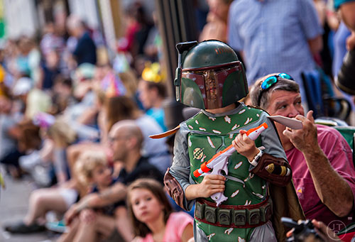 Dressed as Boba Fett, Jackson Lee holds his weapon as he waits for the start of the annual DragonCon Parade in Atlanta on Saturday, September 5, 2015.   