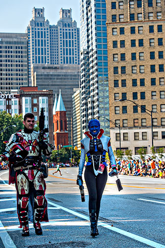 Travis Kling (left) and Rebecca Palmer walk down Peachtree St. as they head towards the marshalling area for the annual DragonCon Parade in Atlanta on Saturday, September 5, 2015.  