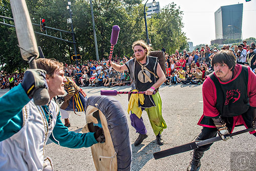 Evan Kennedy (left), Spencer Tousignant and Corey Bender battle in the street as they make their way down Peachtree St. during the annual DragonCon Parade in Atlanta on Saturday, September 5, 2015.   