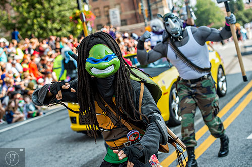 Characters from Teenage Mutant Ninja Turtles make their way down Peachtree St. during the annual DragonCon Parade in Atlanta on Saturday, September 5, 2015.   