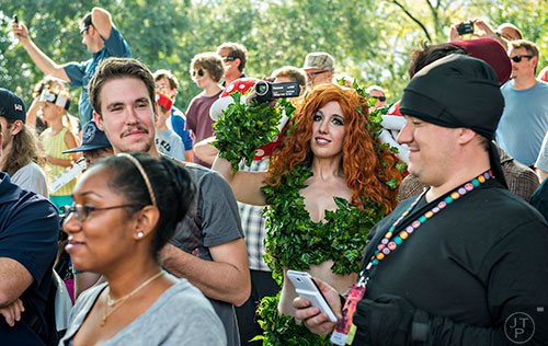 Sarah Nip (center) video tapes the annual DragonCon Parade as it passes by on Peachtree St. in Atlanta on Saturday, September 5, 2015.   