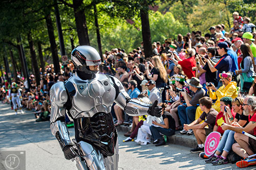 Dressed as RoboCop, Ben Moon gives a thumbs up to the crowd as he marches down Peachtree St. during the annual DragonCon Parade in Atlanta on Saturday, September 5, 2015.   