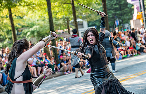 Characters from the 300 movies battle in the street as they make their way down Peachtree St. during the annual DragonCon Parade in Atlanta on Saturday, September 5, 2015.  