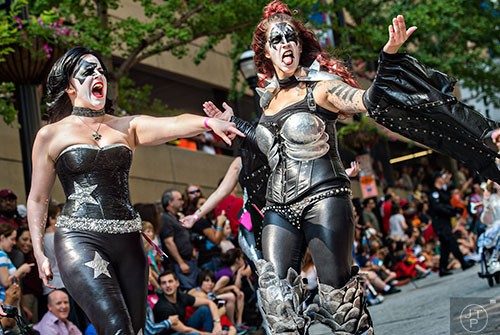 Dressed as members of the band KISS, Maddie Bingham (left) and Linnay Dellaluce play up to the crowd during the annual DragonCon Parade in Atlanta on Saturday, September 5, 2015.   