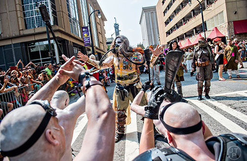 Dressed as Immortan Joe from Mad Max Fury Road, John McDole (center) is worshiped by his War Boys during the annual DragonCon Parade in Atlanta on Saturday, September 5, 2015.   