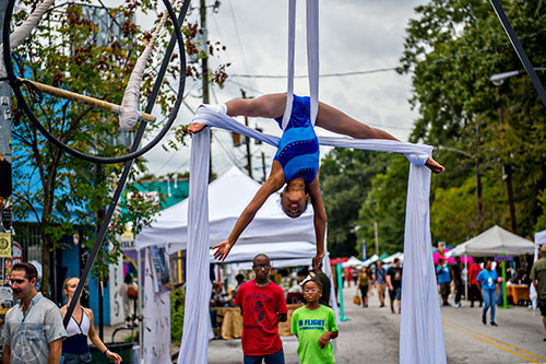 Keslyn Billings performs using silks during the 5 Arts Fest in the Little Five Points neighborhood of Atlanta on Saturday, September 12, 2015.