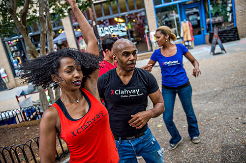 Stacey Suarez (left), Emarlos Whitfield and Yemia White dance in the plaza during the 5 Arts Fest in the Little Five Points neighborhood of Atlanta on Saturday, September 12, 2015. 