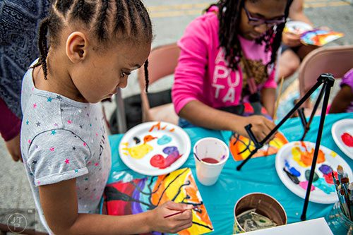 Jasmine Hayes (left) and Kya Trimble learn how to paint pictures of trees during the 5 Arts Fest in the Little Five Points neighborhood of Atlanta on Saturday, September 12, 2015. 