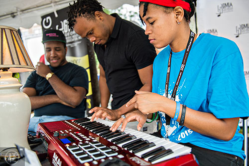 Jodie Ramirez (right), Ron Hinds and Sherman Trotz lay down a keyboard track at the GMIA recording studio during the 5 Arts Fest in the Little Five Points neighborhood of Atlanta on Saturday, September 12, 2015.