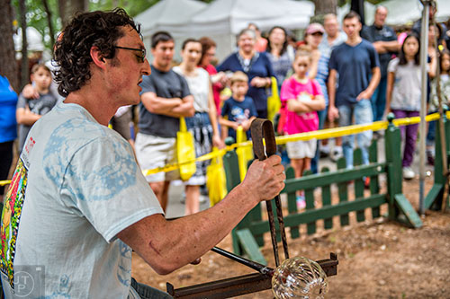Sy Dowling (left) gives a glass blowing demonstration during the Yellow Daisy Festival at Stone Mountain Park on Saturday, September 12, 2015. 