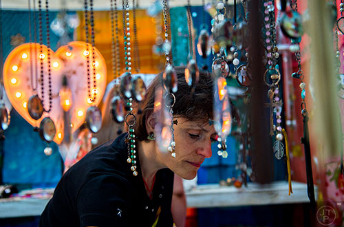 Anna Chambers looks at pieces of jewelry in one of the booths at the Yellow Daisy Festival at Stone Mountain Park on Saturday, September 12, 2015. 