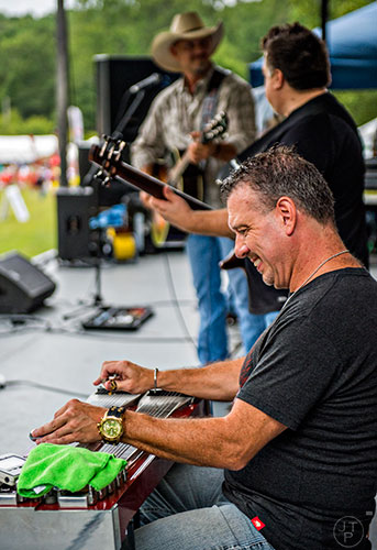 Across the Wide's Tim Hamilton (right), and Kevin Wyglad and Jody Abernathy perform on stage during the Yellow Daisy Festival at Stone Mountain Park on Saturday, September 12, 2015.