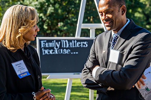 Bethaney Willis (left) speaks with Joe Arnold before the start of the Families First groundbreaking ceremony at the historic E.R. Carter Elementary School in Atlanta on Thursday, September 17, 2015. 