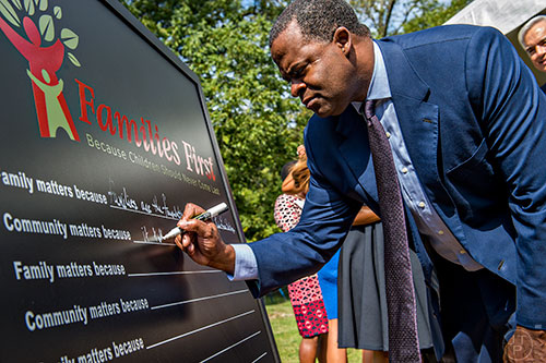 Atlanta Mayor Kasim Reed writes why he thinks community matters during the Families First groundbreaking ceremony at the historic E.R. Carter Elementary School in Atlanta on Thursday, September 17, 2015. 