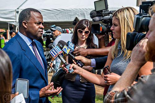 Atlanta Mayor Kasim Reed (left) speaks with members of the media after the Families First groundbreaking ceremony at the historic E.R. Carter Elementary School in Atlanta on Thursday, September 17, 2015. 