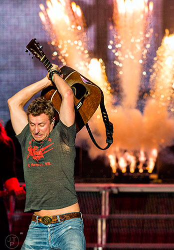Dierks Bentley acts like he is going to smash his guitar as he performs on stage at Verizon Wireless Amphitheatre in Alpharetta during the 94.9 The Bull's Big Country Fan Jam on Saturday, September 19, 2015.   