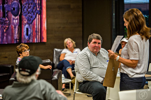 Robert Morris (center) listens to instructions at the start of a focus group at the Pulte Group's Innovation Center in Norcross on Monday, September 14, 2015. 