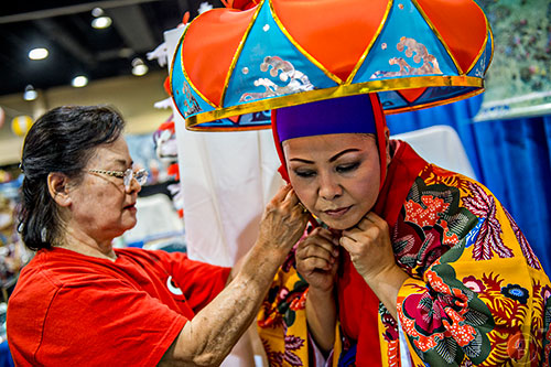 Tsuruko Saunders (left) helps Kaori Robinson secure her head piece during JapanFest at the Infinite Energy Center in Duluth on Saturday, September 19, 2015.  