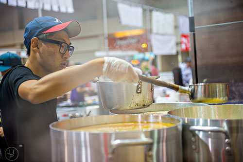 Joon Kang ladles soup into a bowl during JapanFest at the Infinite Energy Center in Duluth on Saturday, September 19, 2015. 