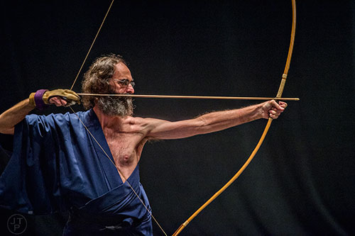 Aaron Blackwell draws his bow in a kyudo demostration during JapanFest at the Infinite Energy Center in Duluth on Saturday, September 19, 2015.  