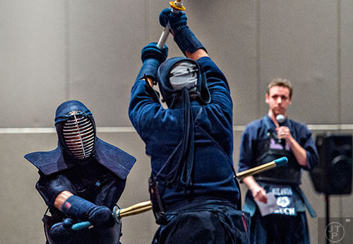 Victor Kuh (left) makes contact with Hayato DeSouza in a kendo demonstration during JapanFest at the Infinite Energy Center in Duluth on Saturday, September 19, 2015.  