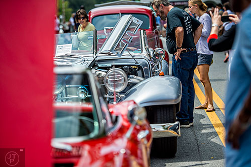 Mike Schmidt (right) looks at a 1936 Mercedes 540K Spezial Roadster during the Marietta StreetFest in the historic downtown square on Saturday, September 19, 2015.  