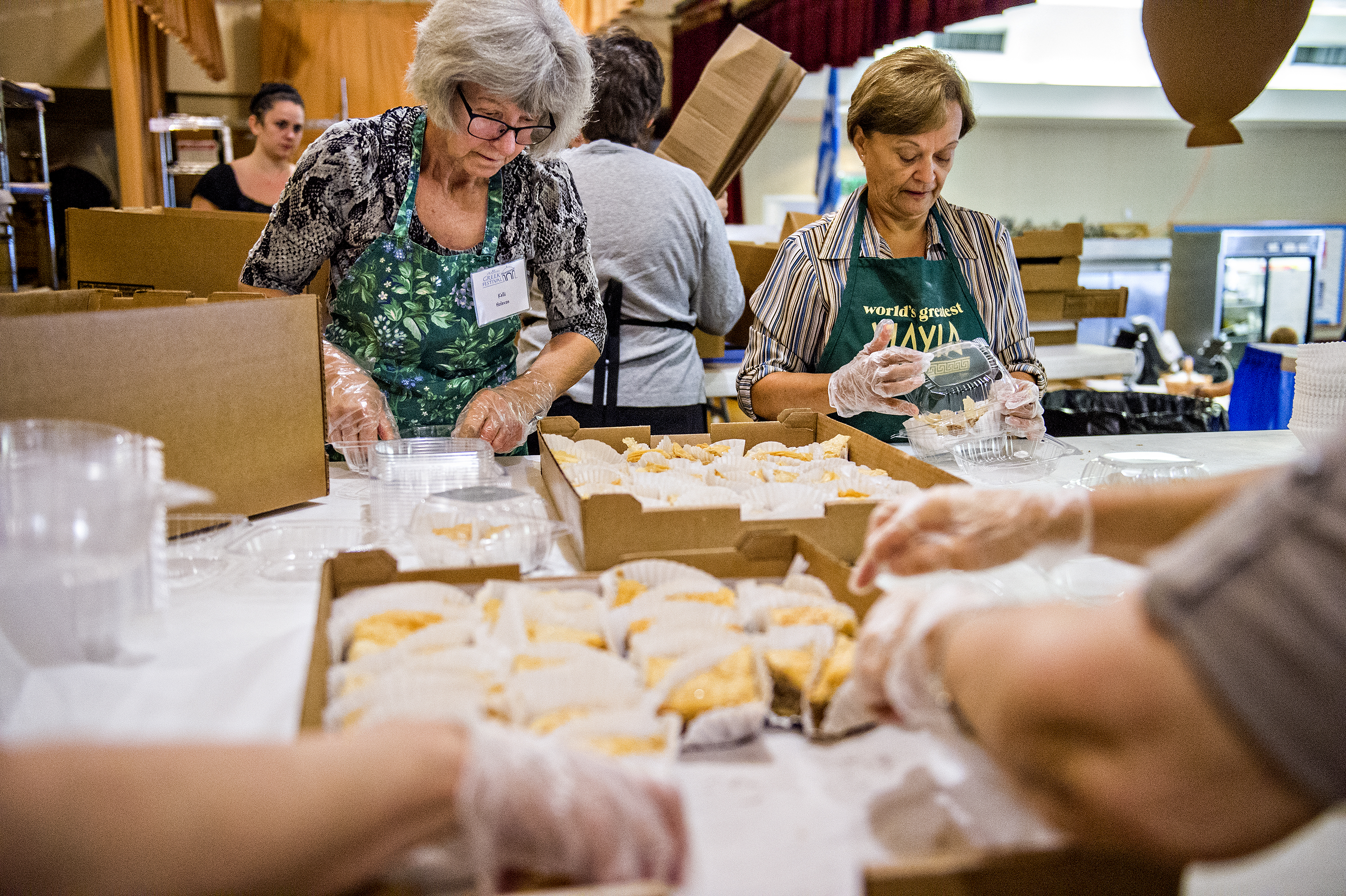 Kelli Holevas (left) and Amy Lekos fill pastry orders as they stuff containers with baklava during the Atlanta Greek Festival at the Greek Orthodox Cathedral of Annunciation on Saturday, September 26, 2015.